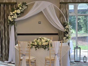 Circular backdrop arch creating an elegant focal point for wedding venue styling