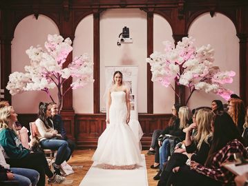 Large blossom tree creating an elegant statement feature for wedding venue styling 