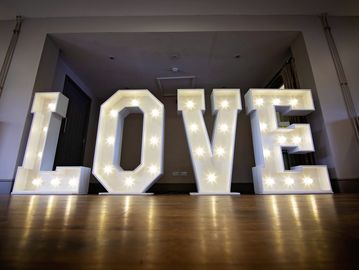 White light up LOVE letters for wedding venue styling