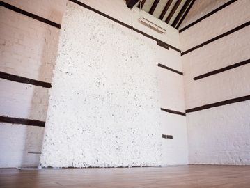 Ivory flower wall backdrop creating an elegant statement feature for wedding venue styling