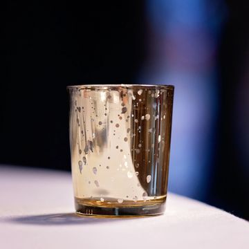 Elegant gold tea light holder for wedding and event table styling.