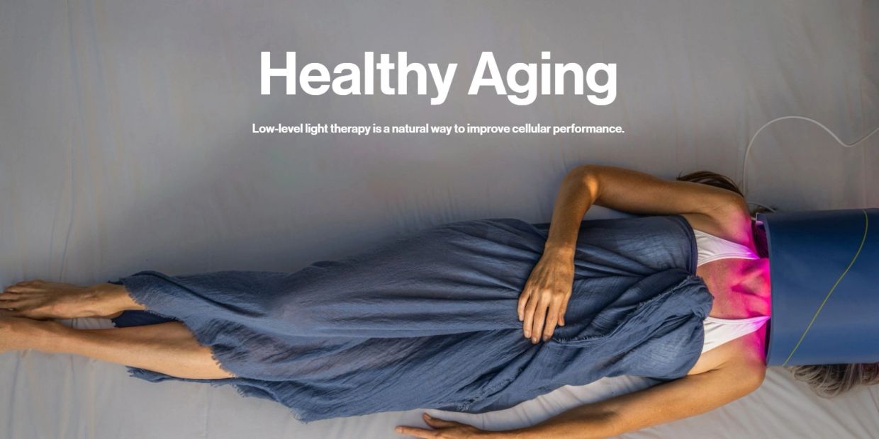 Woman lying down undergoing low-level light therapy for healthy aging.
