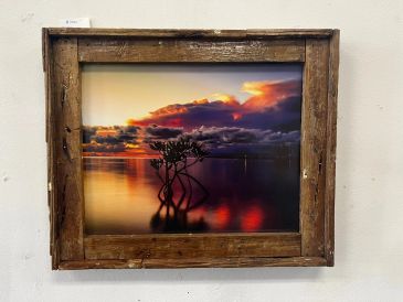 Sunset painting in a rustic wooden frame.