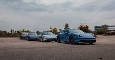Four Porsche Taycan's in a line in parking lot