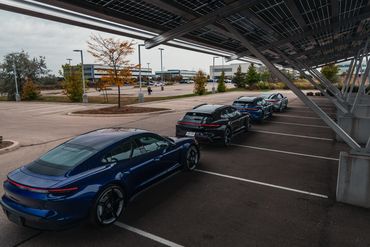 Four Porsche Taycan's in a line in parking lot