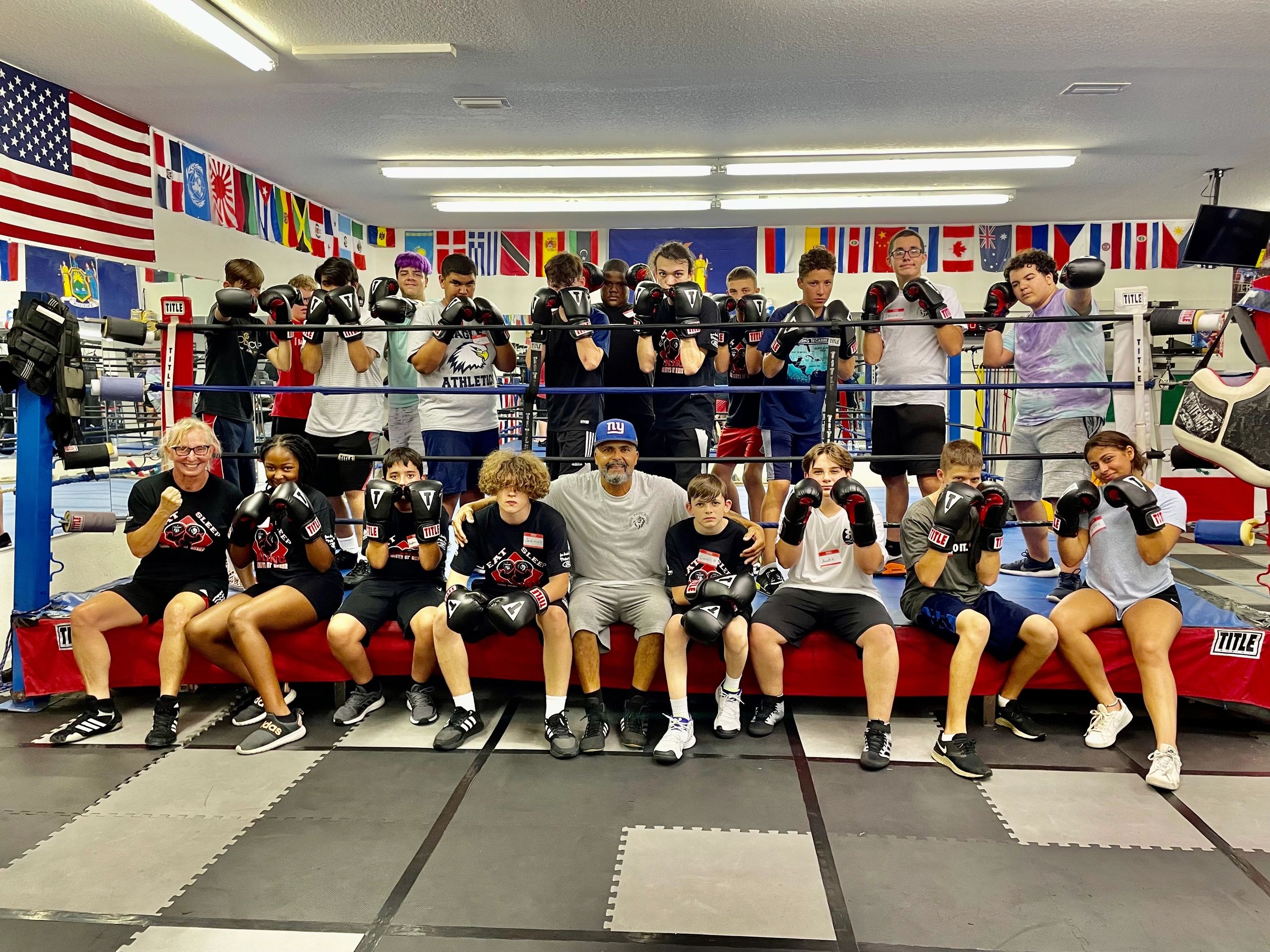 Boxing students and coaches posing in the ring at Lions Pride Boxing & MMA gym in Palm Coast