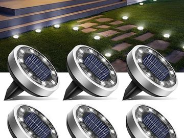 Solar-powered garden pathway lights with round design.