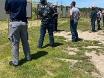 Group of students lining up on the shooting range for instruction.