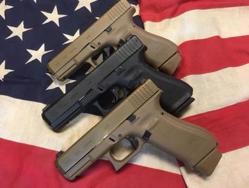 Glock pistols on American flag.