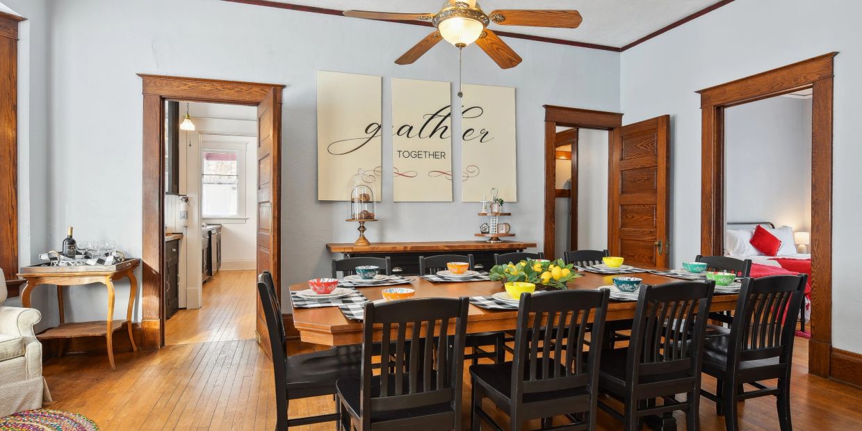 Dining room with wooden furniture and colorful tableware.