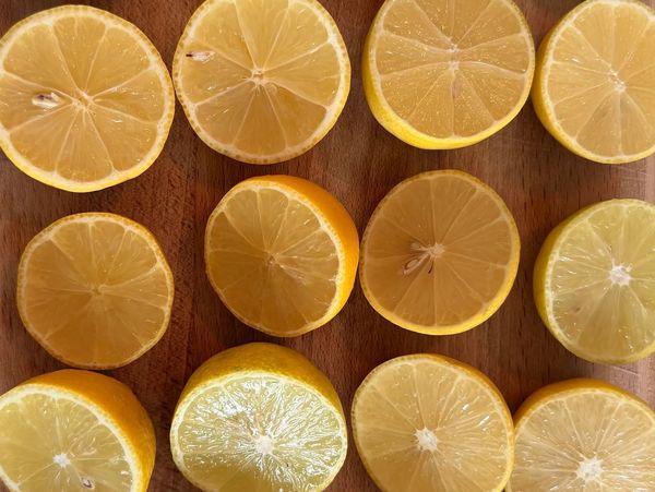 Halved lemons arranged neatly on a wooden surface.