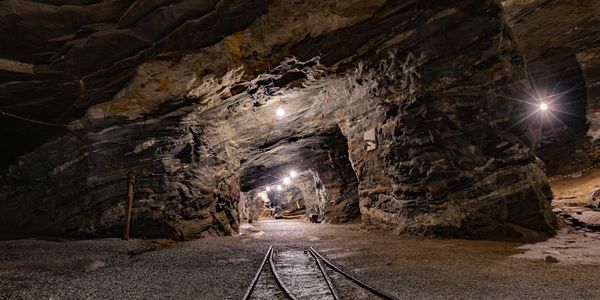 Illuminated rail track in an underground mine in South America.  