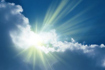 A shining rays behind a cloud