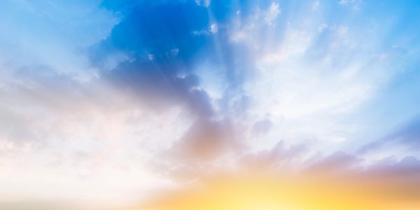 Orange sky dawning on a blue, cloudy sky