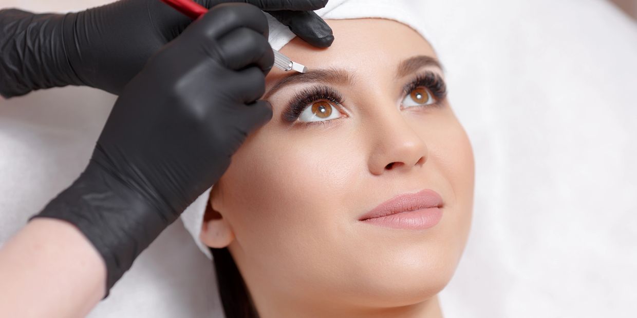 Lady having her eyebrows Microbladed by a microblading artist