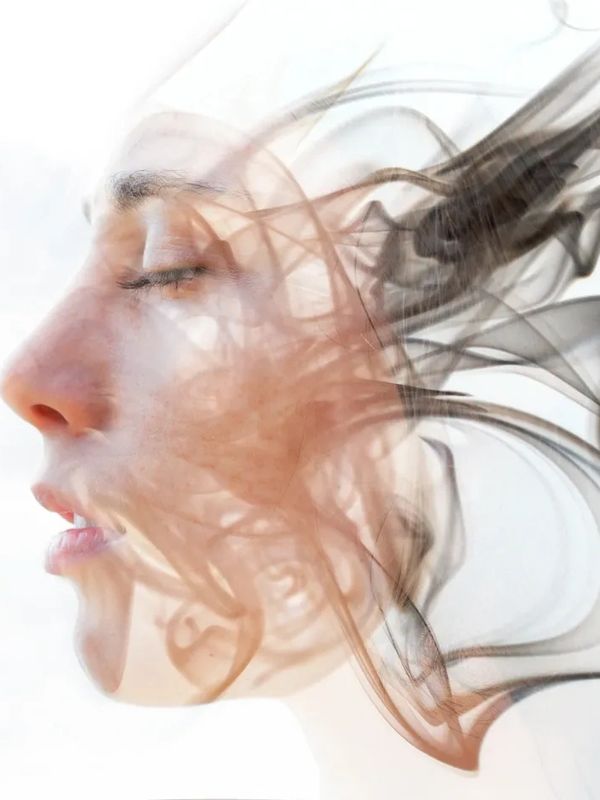 whispy image of woman's face, eyes closed, depicting thoughts swirling around and through the image