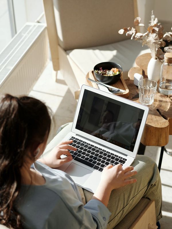 A person accessing counselling through a laptop
