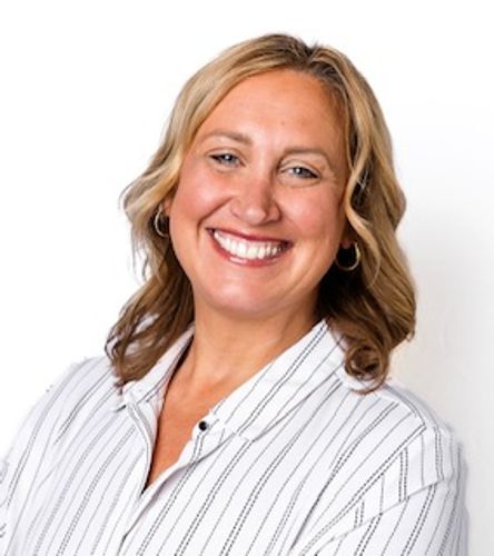 Stack of books next to pencils in a holder and a camera.