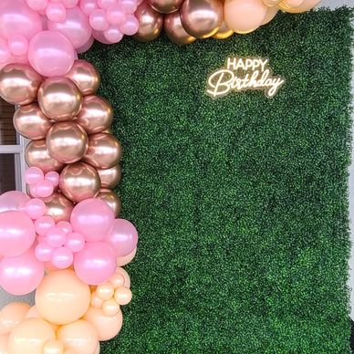 Birthday backdrop with pink and gold balloons and greenery.  Photobooth rental - Tehachapi.