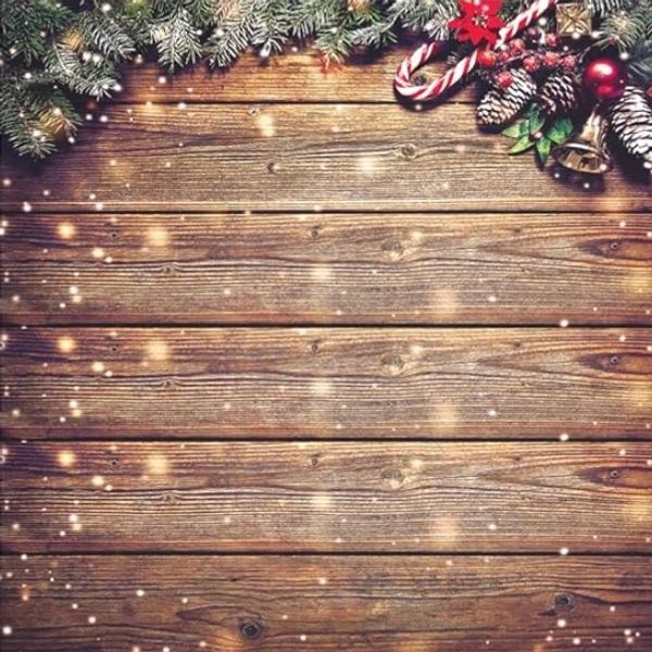 Festive Christmas decorations on wooden background with lights and snow.