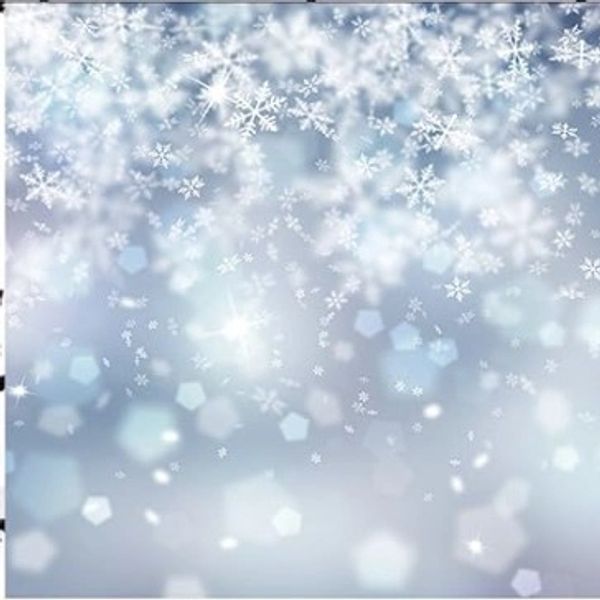 A dreamy winter scene with delicate snowflakes and soft light bokeh.