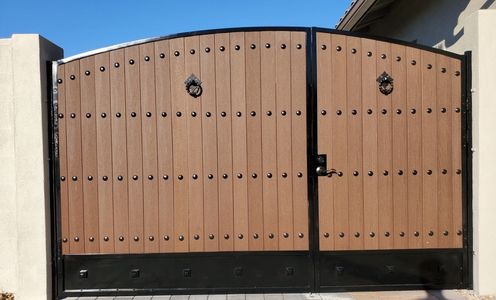 A large double door gate made of wood with metal handles