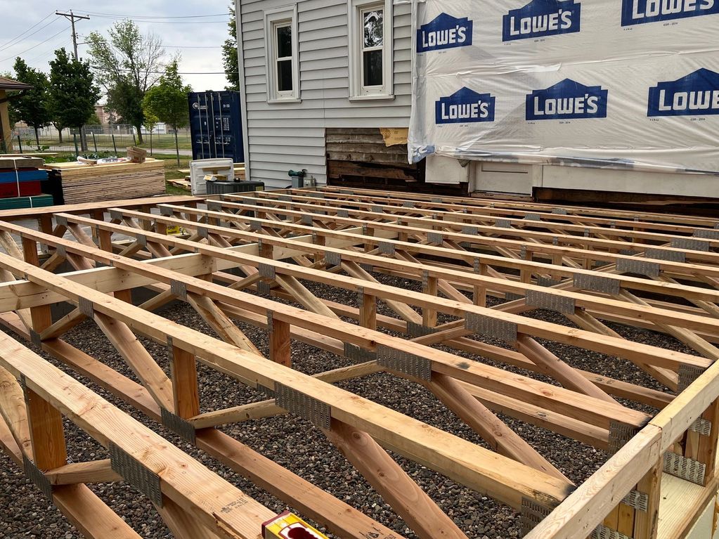 Setting floor trusses for an addition in St. Paul. 