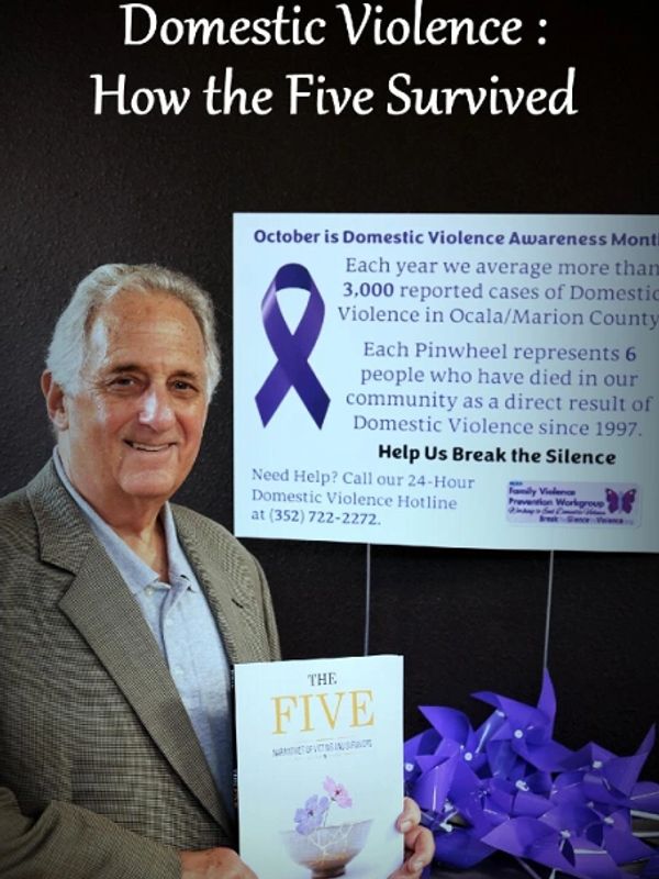 Author of the Five: Narratives of Victims and Survivors smiling while displaying the book