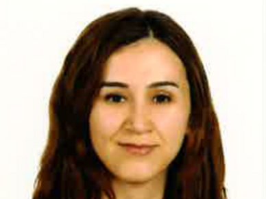 Portrait of a woman with long brown hair and a slight smile.