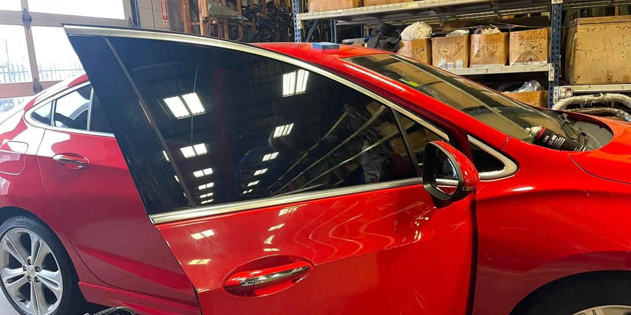 red car with dark tinted windows