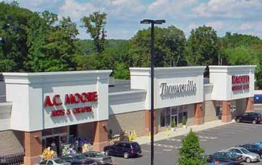 A shopping plaza with stores including A.C. Moore, Thomassville, and a liquor store.