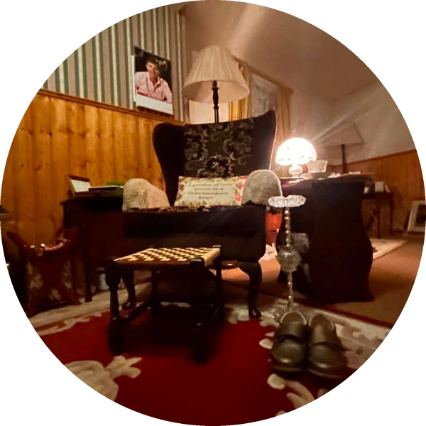 Cozy vintage living room with armchair and slippers.