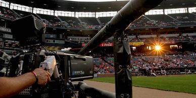 Camera filming a baseball stadium during a game.