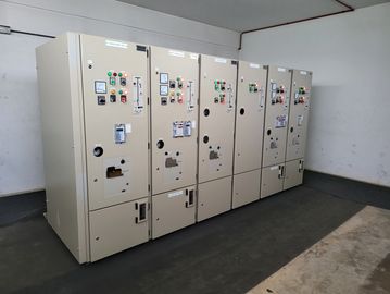 A row of industrial electrical control panels in a room.