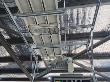 Industrial electrical panel with overhead cable trays in a facility.