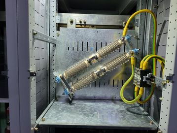 Close-up of electrical components inside a metal cabinet.