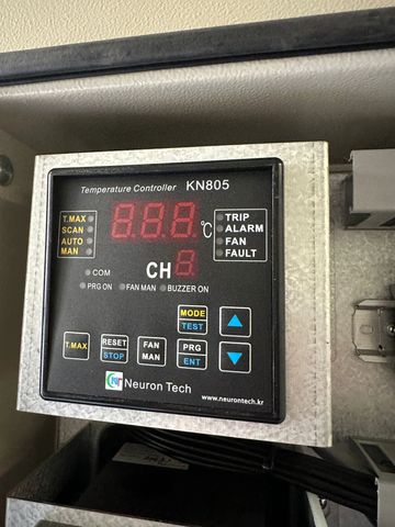 Close-up of a Neuron Tech KN805 temperature controller with digital display and control buttons.