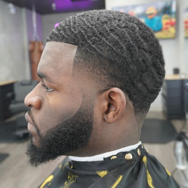 Man with a fresh wave haircut and beard.
