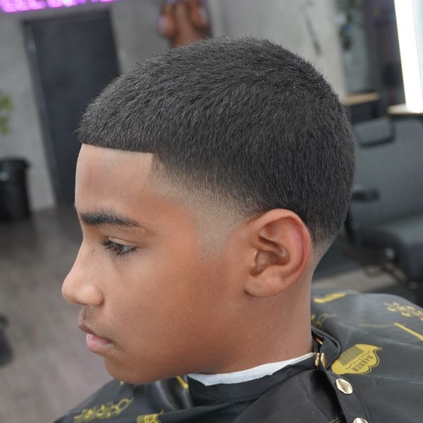 Young man with a fresh fade haircut in a barber shop.