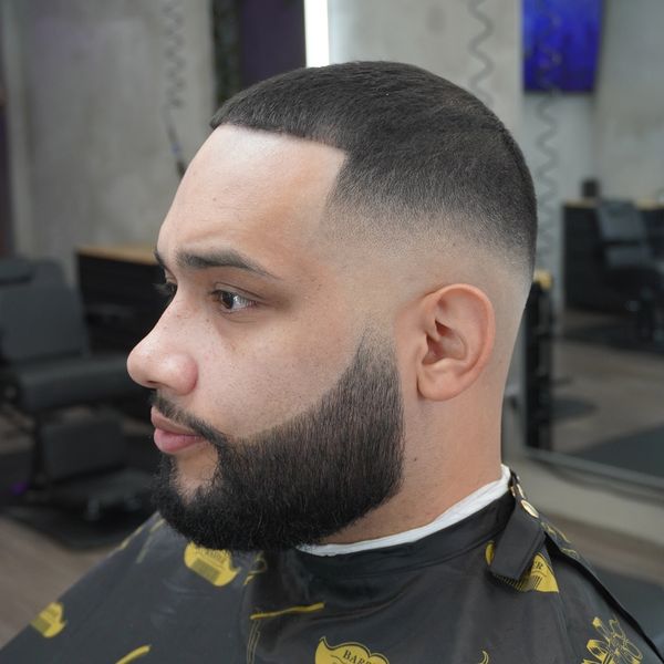Man with fresh fade haircut and beard trim.