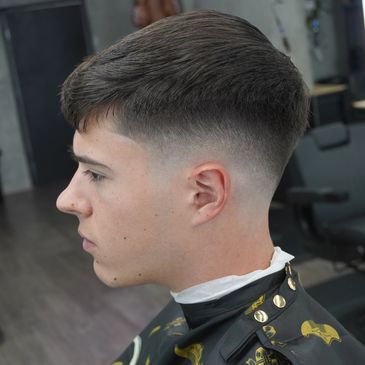 Young man with a fresh fade haircut.
