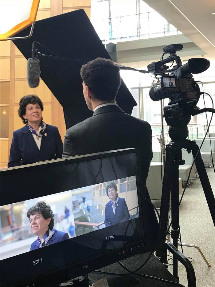 Two people conducting an on-camera interview
