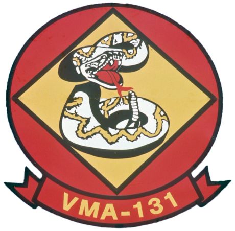 Emblem of VMA-131 featuring a coiled rattlesnake with a red tongue.