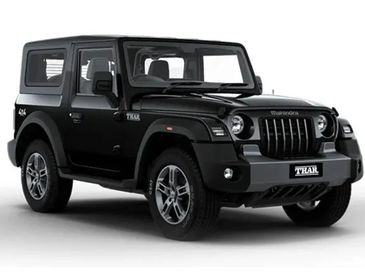 Black Mahindra Thar SUV parked on white background.