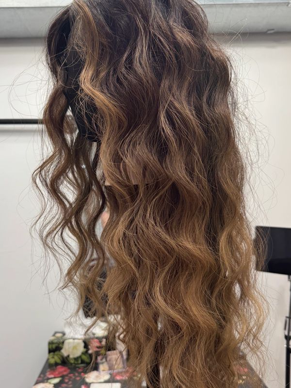 Long wavy ombre brown hair on a mannequin head.