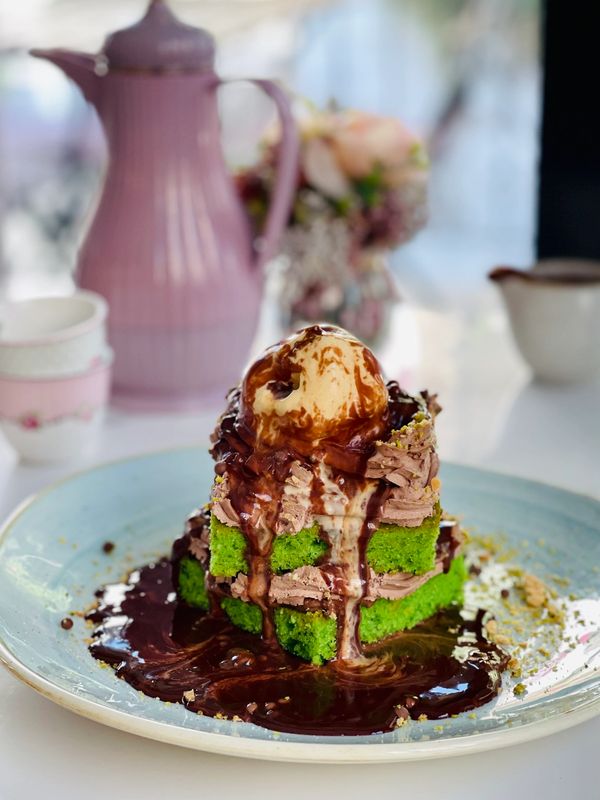 Dessert: pistachio cake with chocolate mousse, ice cream and hot chocolate sauce. Arabic Coffee.