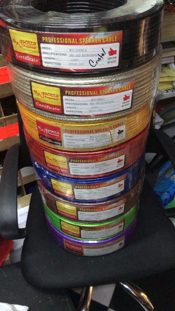 Stack of colorful professional speaker cables on a black chair.