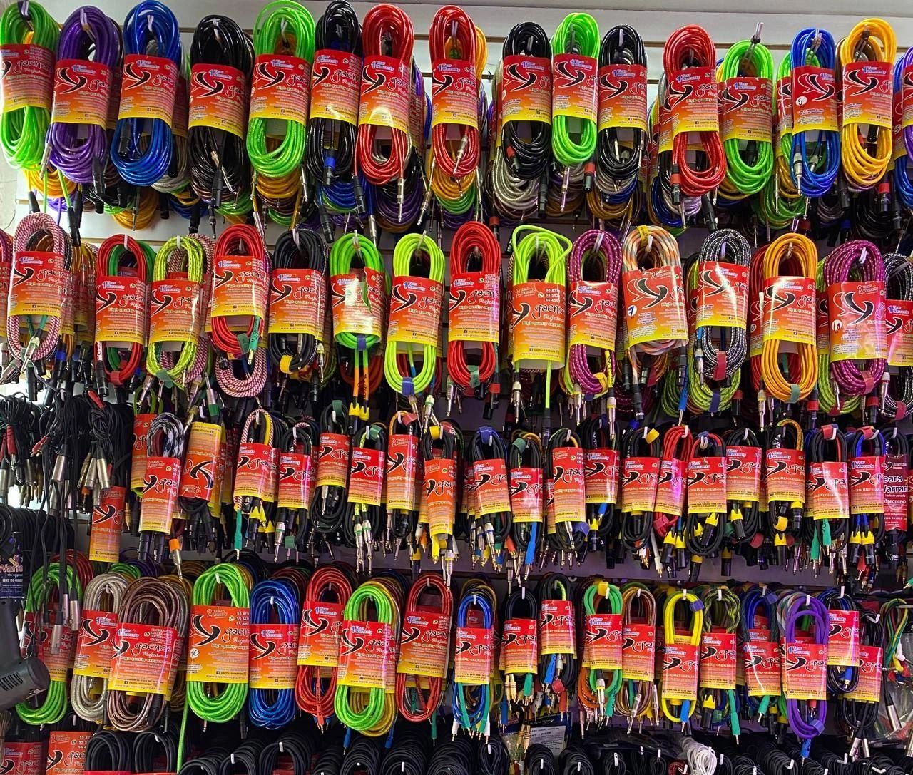 Colorful audio cables neatly arranged on a display wall.