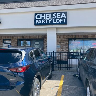 Exterior of Chelsea Party Loft with parked cars.