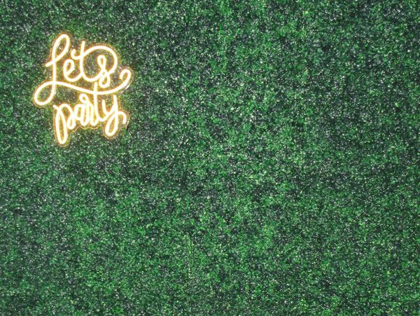 A lush faux greenery wall backdrop at Chelsea Party Loft, perfect for guest photos and selfies.